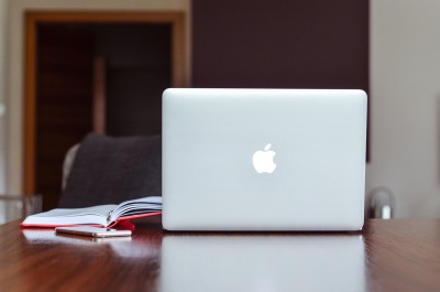 Laptop workspace with accounting software, wide format