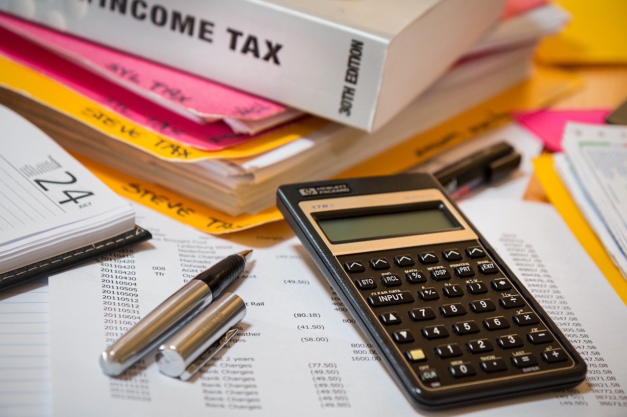 Tax documents and calculator on desk